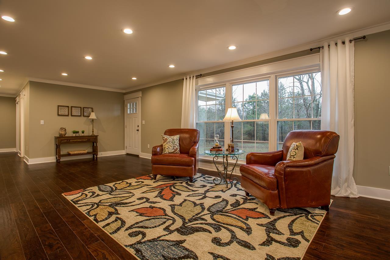 83 You Take It Road Ardmore, TN 38449 - Photo 3 of 30 a living room with furniture and wooden floor