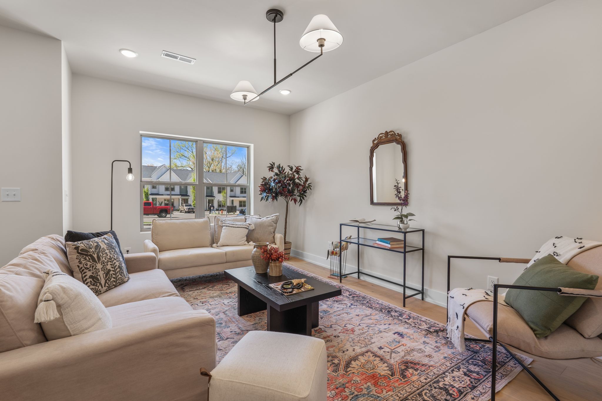 a living room with furniture a rug and white walls