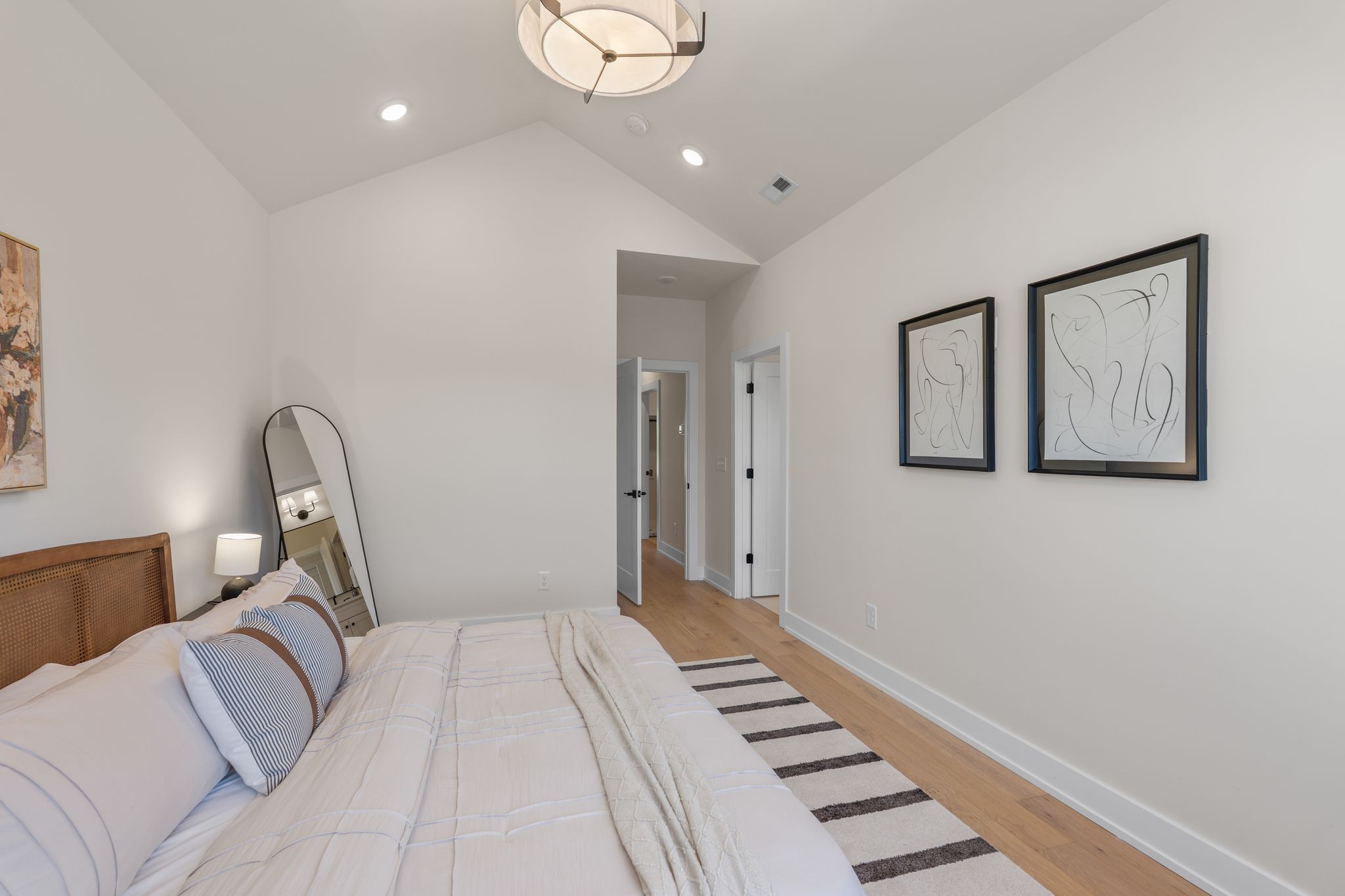 145 Whitsett Road, Unit 29 Nashville, TN 37210 - Photo 19 of 27 a bedroom with a bed and a chandelier