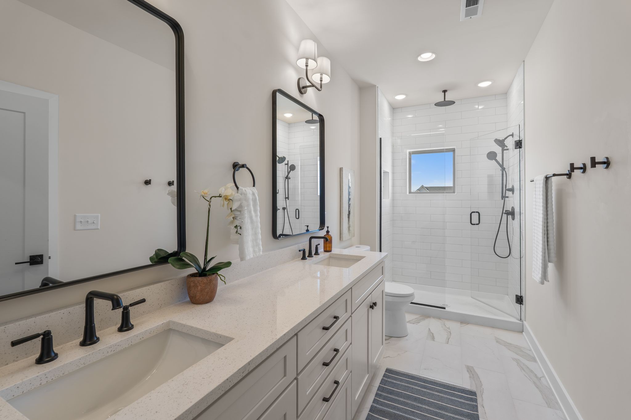145 Whitsett Road, Unit 29 Nashville, TN 37210 - Photo 21 of 27 a bathroom with a double vanity sink mirror and shower