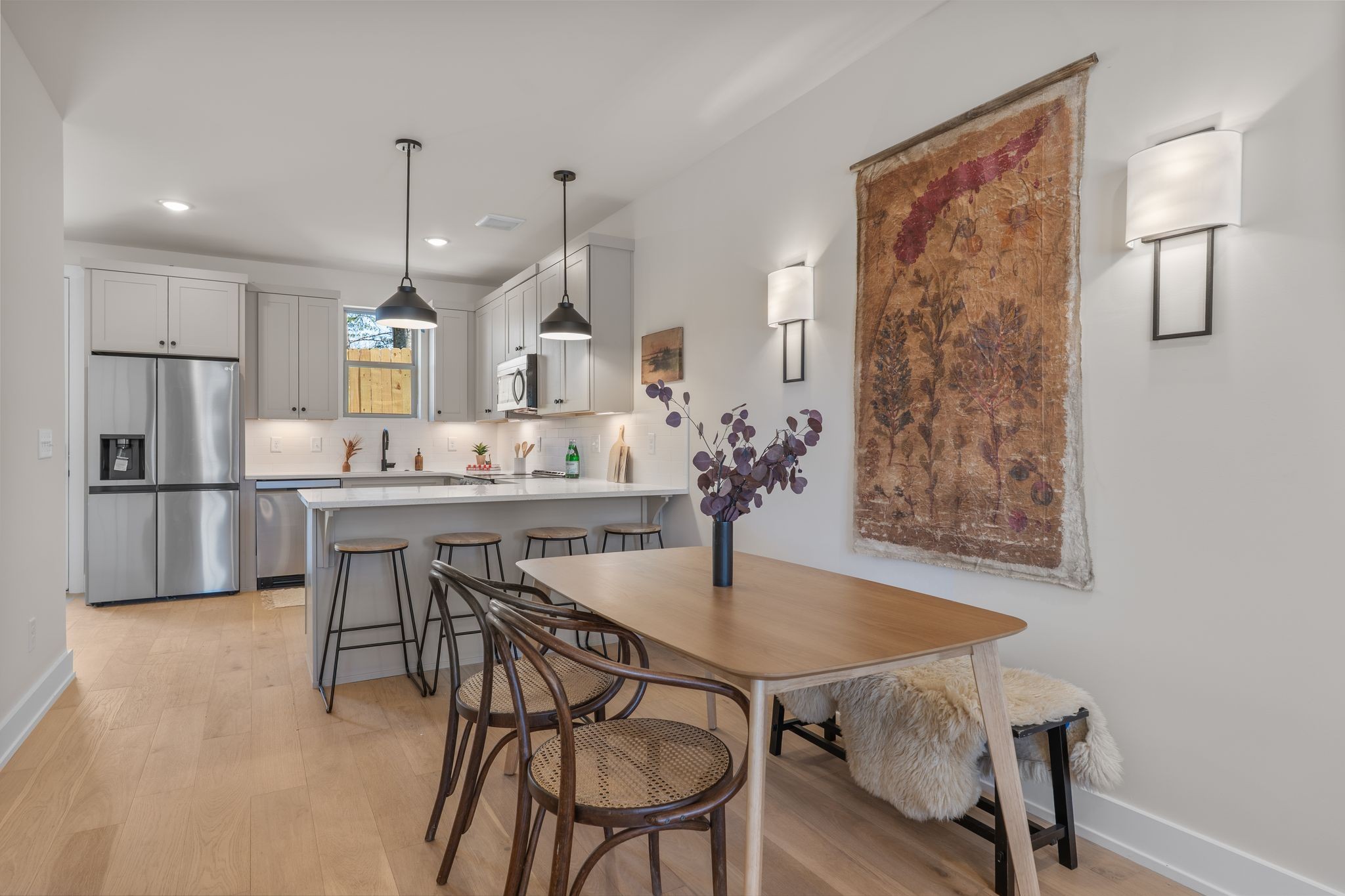 145 Whitsett Road, Unit 29 Nashville, TN 37210 - Photo 8 of 27 a kitchen with stainless steel appliances kitchen island granite countertop a dining table chairs and a refrigerator