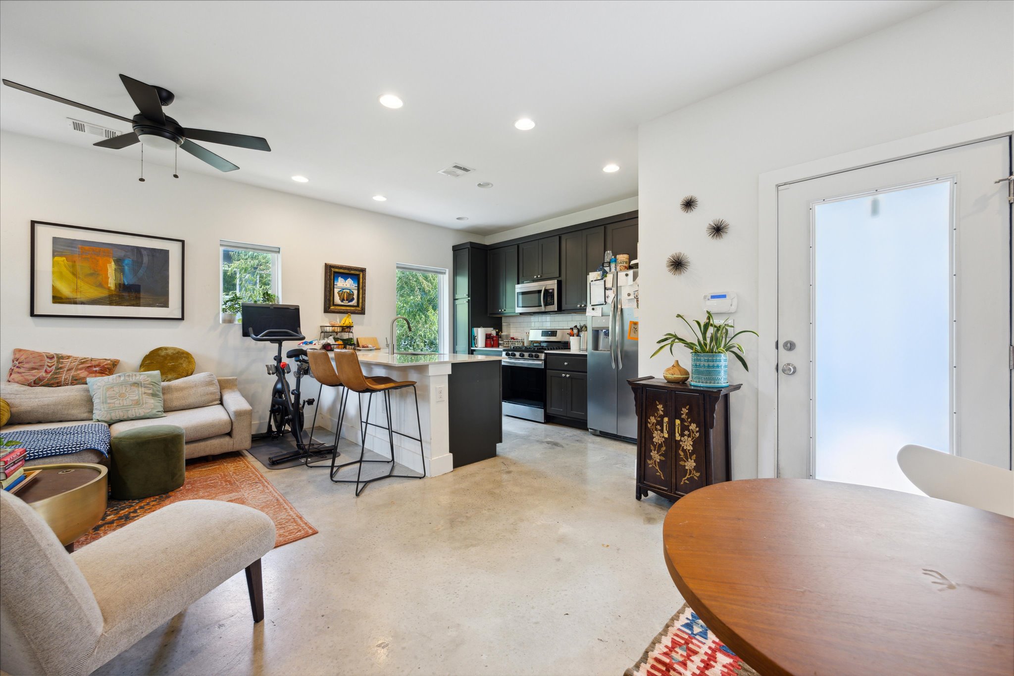 5006 Baker Street, Unit B Austin, TX 78721 - Photo 1 of 16 a living room with furniture kitchen view and a wooden floor