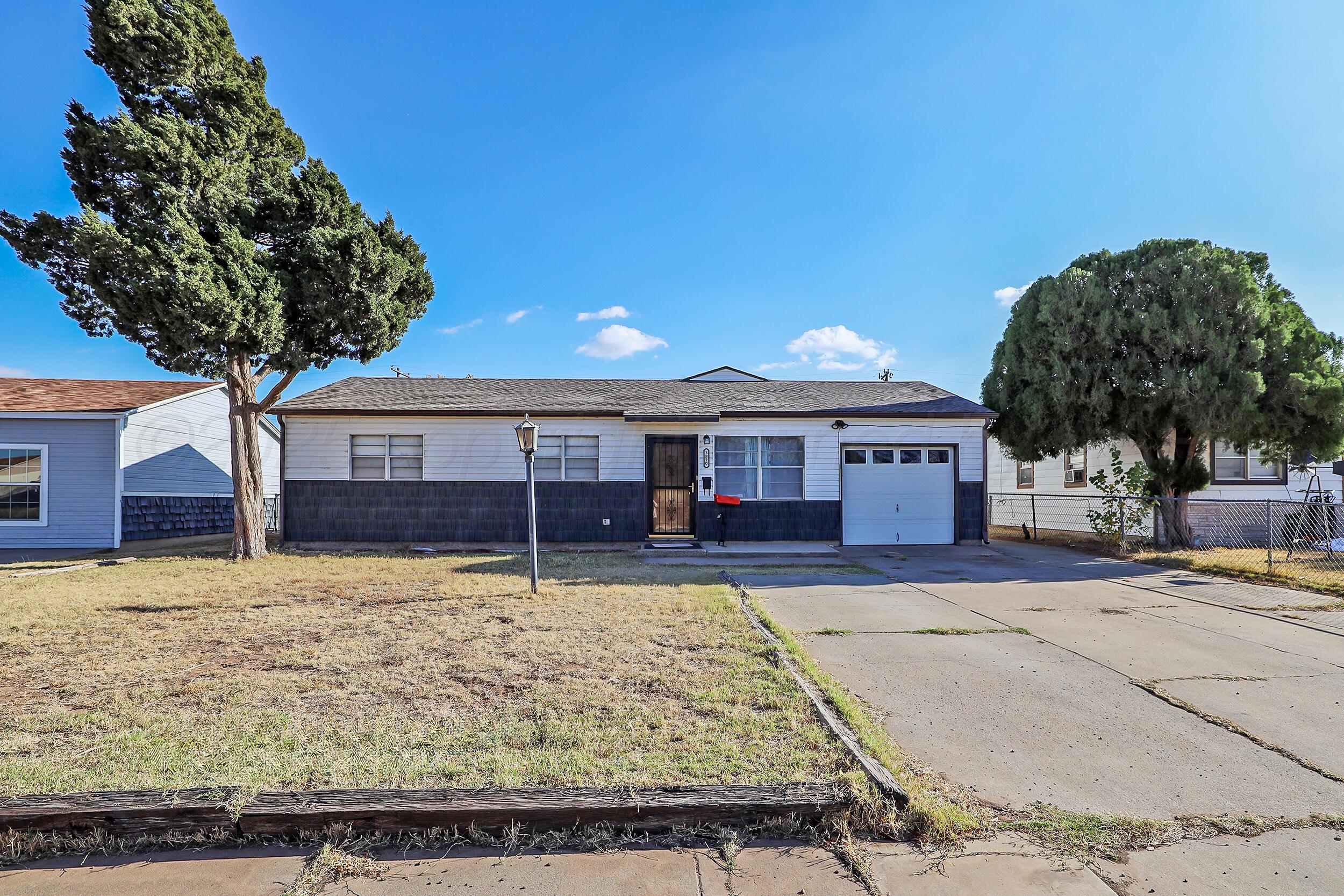 3820 Beaver Drive Amarillo, TX 79107 - Photo 2 of 24 a front view of a house with a yard and garage