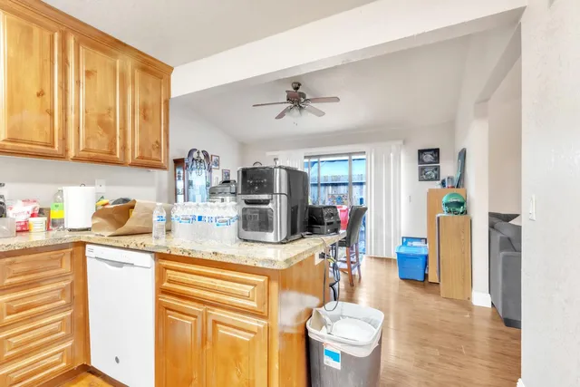 a dining room with furniture one side view and wooden floor