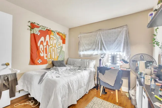 a bedroom with a bed and a flat screen tv