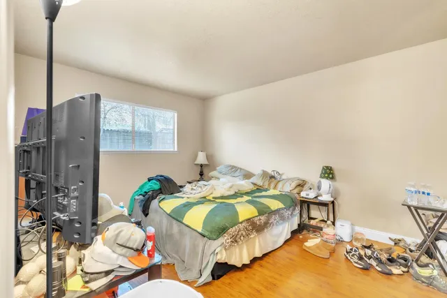a bedroom with furniture and a flat screen tv