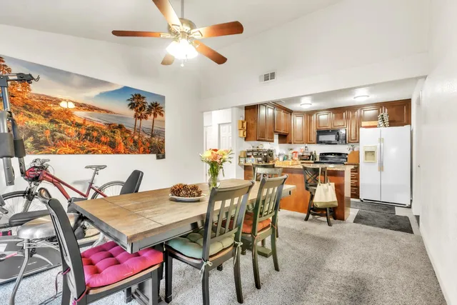 a view of a dining room with furniture and a chandelier