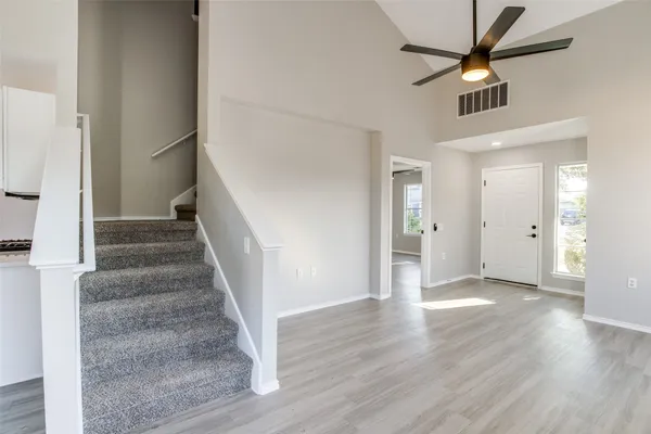 a view of an entryway with wooden floor