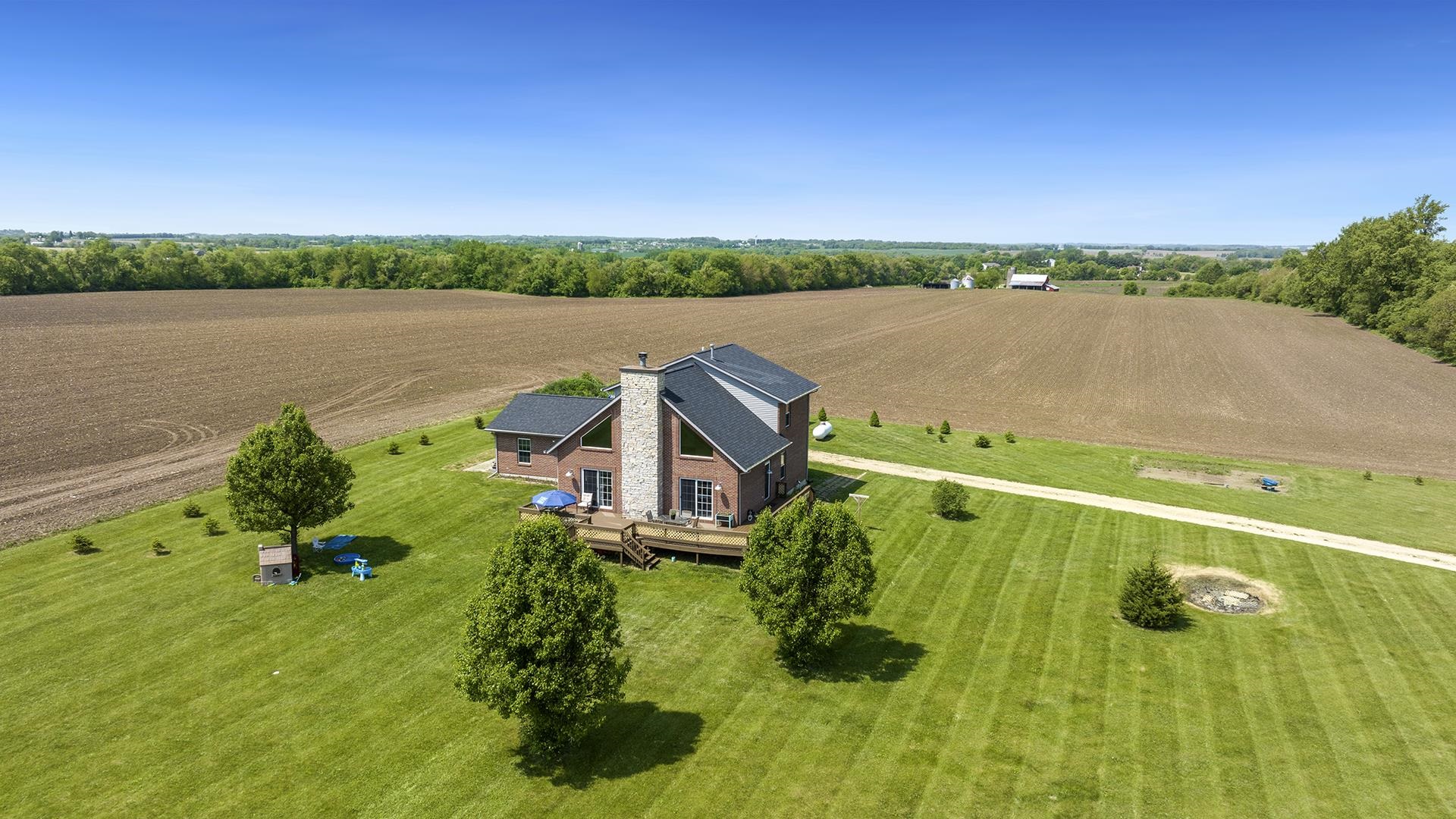 5108 North Winnebago Road Winnebago, IL 61088 - Photo 2 of 50 a view of a lake with a big yard