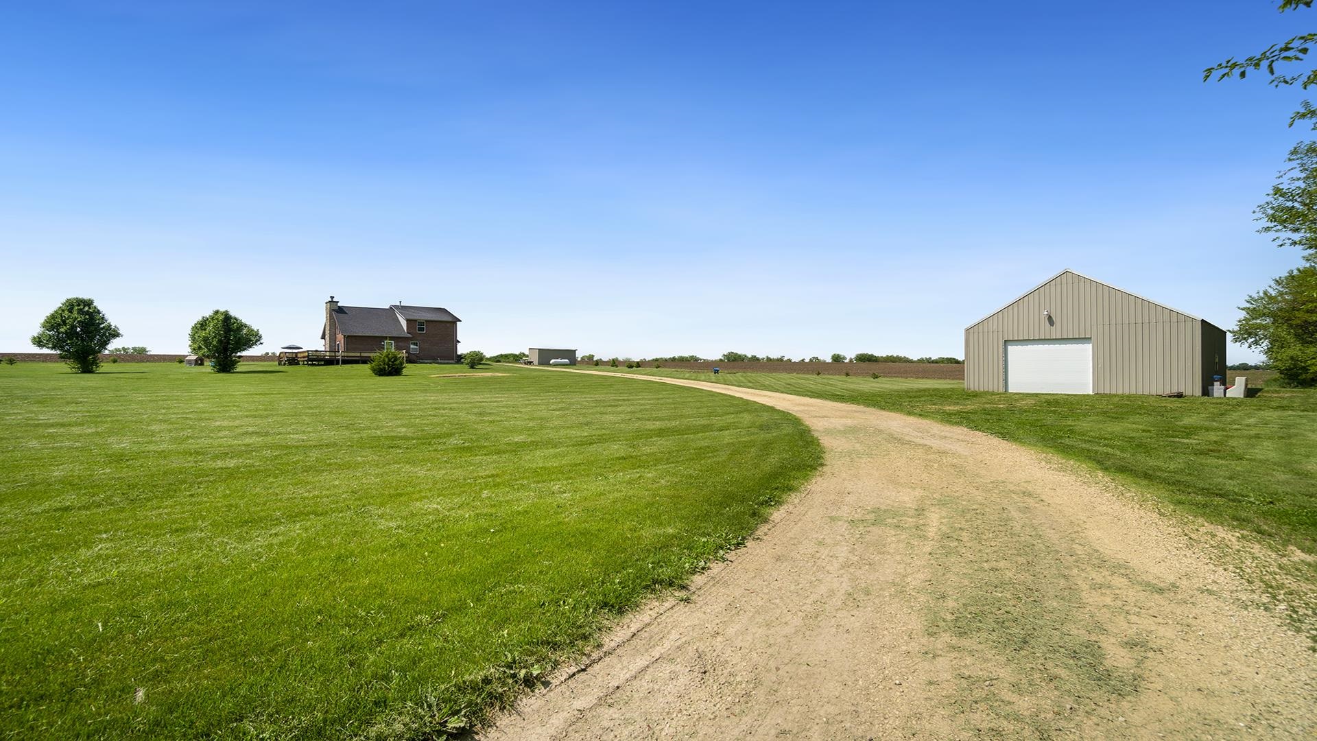 5108 North Winnebago Road Winnebago, IL 61088 - Photo 38 of 50 a view of a house with a yard