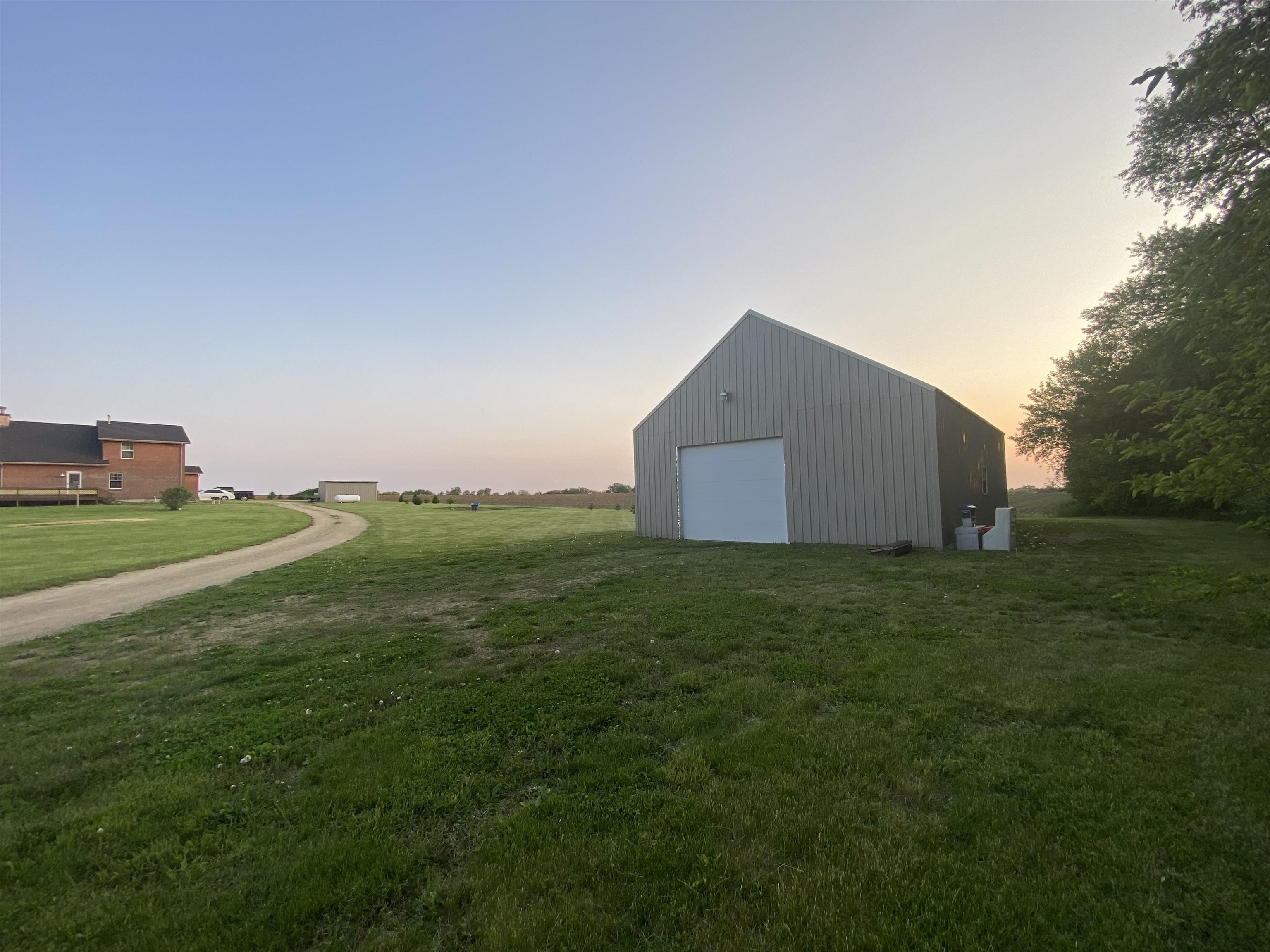 5108 North Winnebago Road Winnebago, IL 61088 - Photo 50 of 50 a backyard of a house with lots of green space and mountain view in back