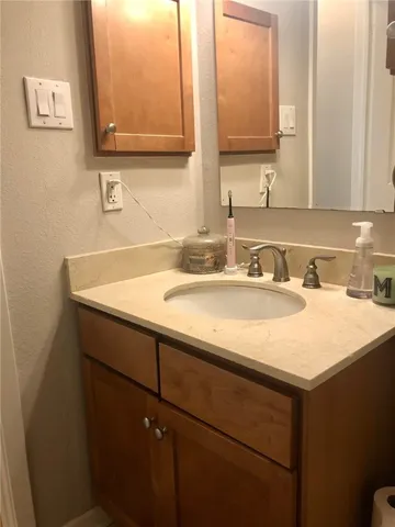 a bathroom with a sink vanity and a mirror