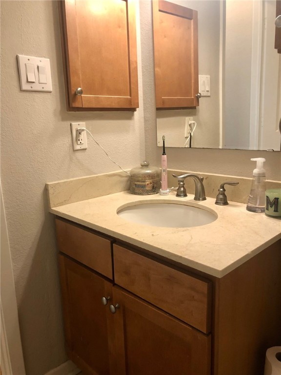 3204 Menchaca Road, Unit 315 Austin, TX 78704 - Photo 12 of 26 a bathroom with a sink vanity and a mirror