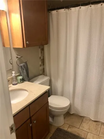 a bathroom with a toilet a sink and a window