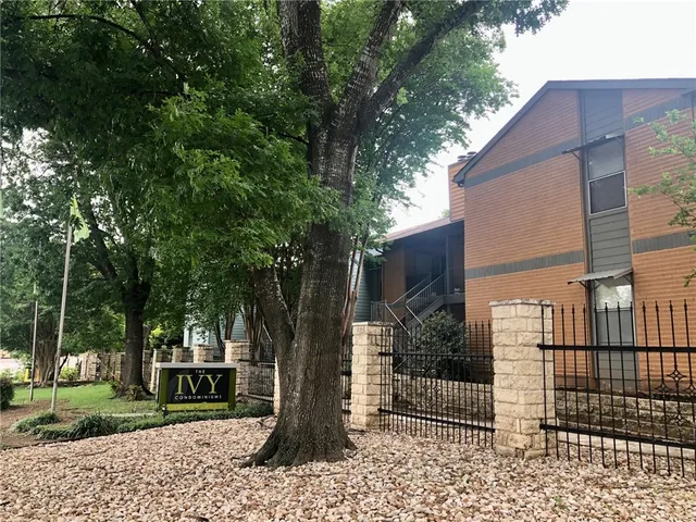 a front view of a house with a tree