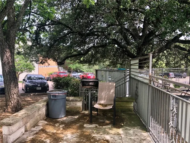 a utility room with stainless steel appliances a sink and a fireplace