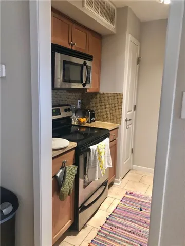 a kitchen with a stove and a microwave