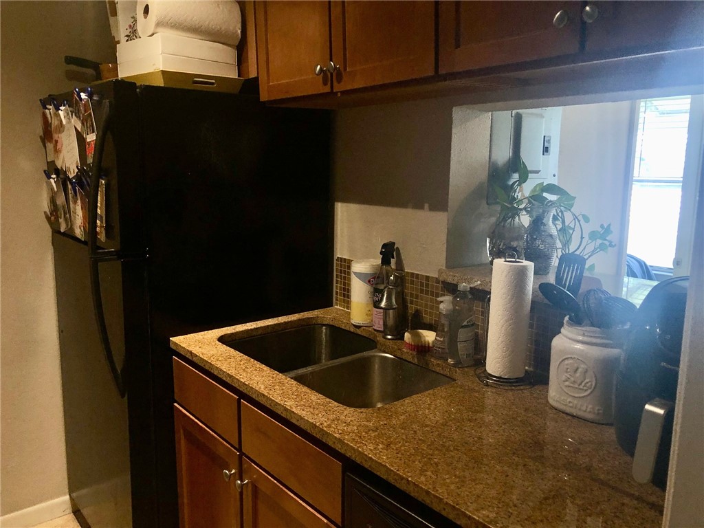 3204 Menchaca Road, Unit 315 Austin, TX 78704 - Photo 5 of 26 a kitchen with a sink and refrigerator