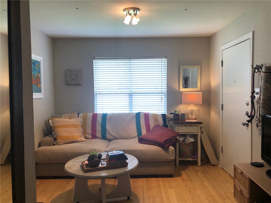 3204 Menchaca Road, Unit 315 Austin, TX 78704 - Photo 8 of 26 a living room with furniture and a wooden floor