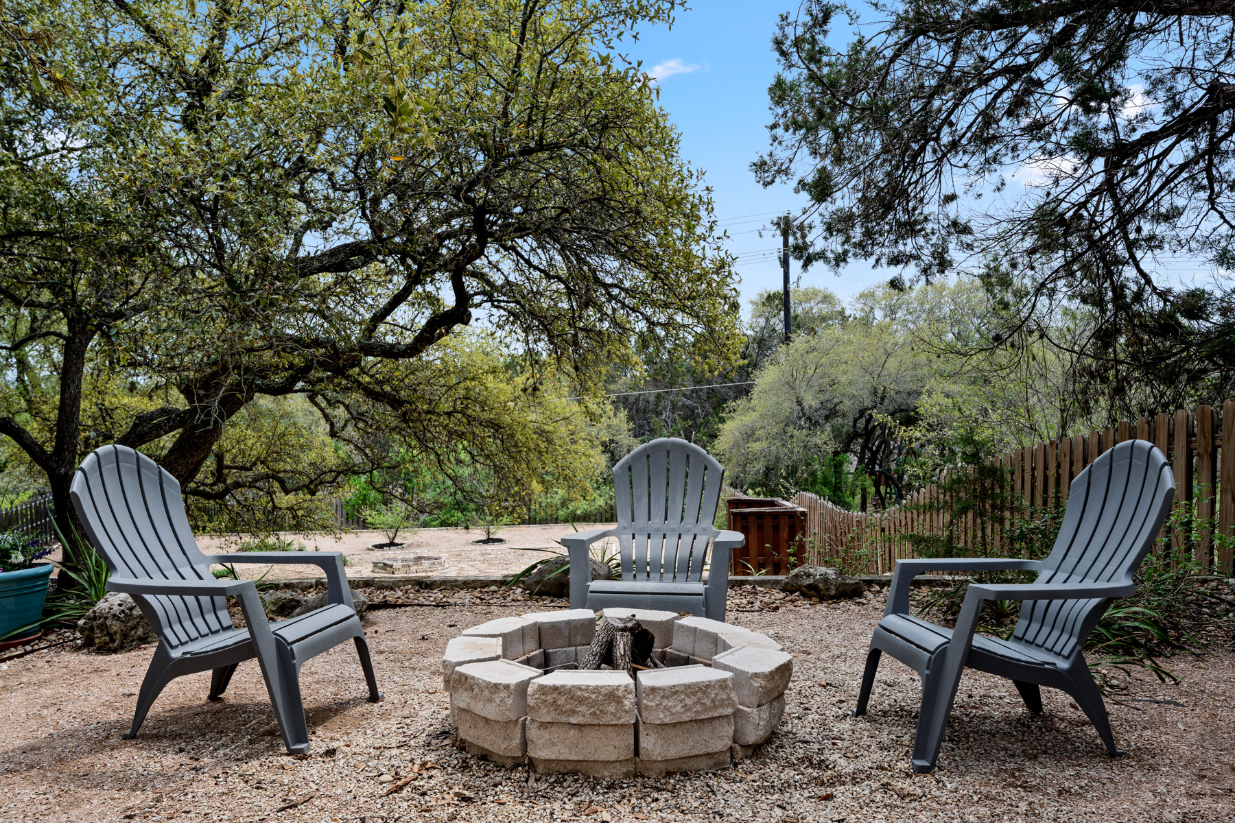 102 Hurst Creek Road Lakeway, TX 78734 - Photo 28 of 29 a view of a chairs and table in backyard