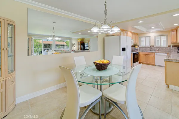 a view of a dining room with furniture and chandelier