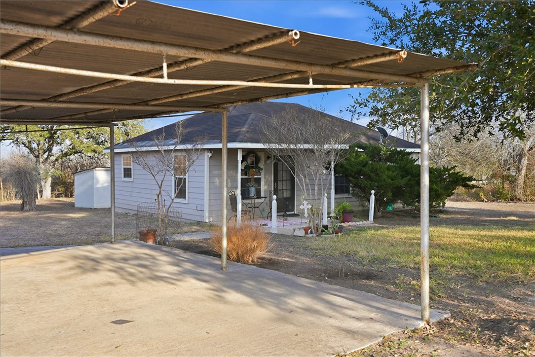 3260 Highway 281 George West, TX 78022 - Photo 21 of 34 a patio with a table and chairs under an umbrella