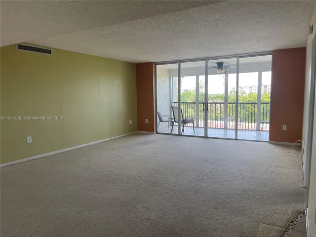 a view of an empty room with a sliding door
