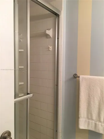 a bathroom with a glass shower door