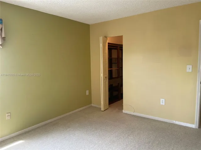 an empty room with a mirror