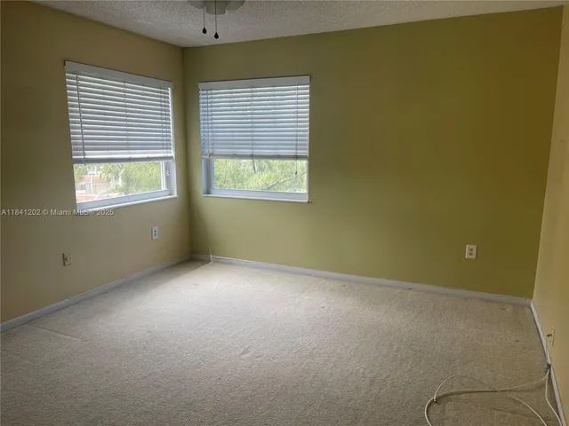 a view of a livingroom and a chandelier fan