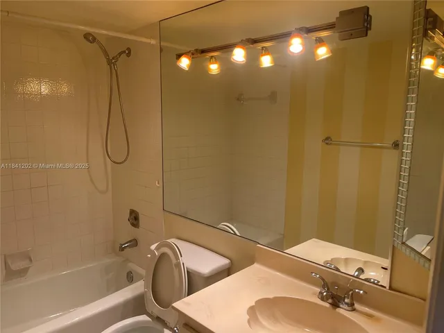 a bathroom with a sink a toilet and bathtub