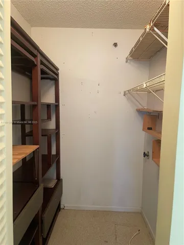 a view of a room with lounge chair and windows