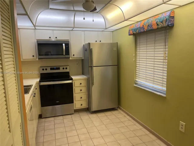 a kitchen with a refrigerator and a stove