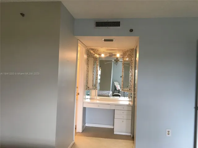 a bathroom with a sink mirror and vanity