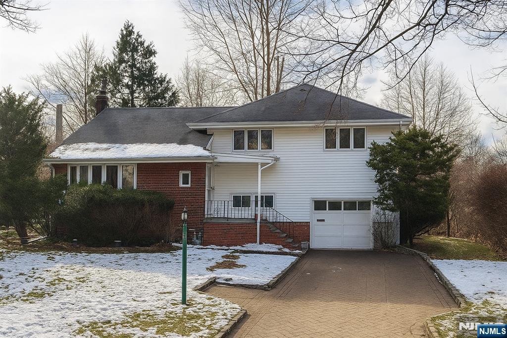 10 Center Street Cresskill, NJ 07626 - Photo 1 of 8 a front view of a house with garden