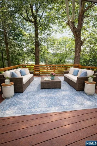 a living room with furniture and a large tree