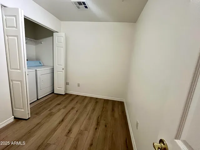 a view of a room with wooden floor and closet