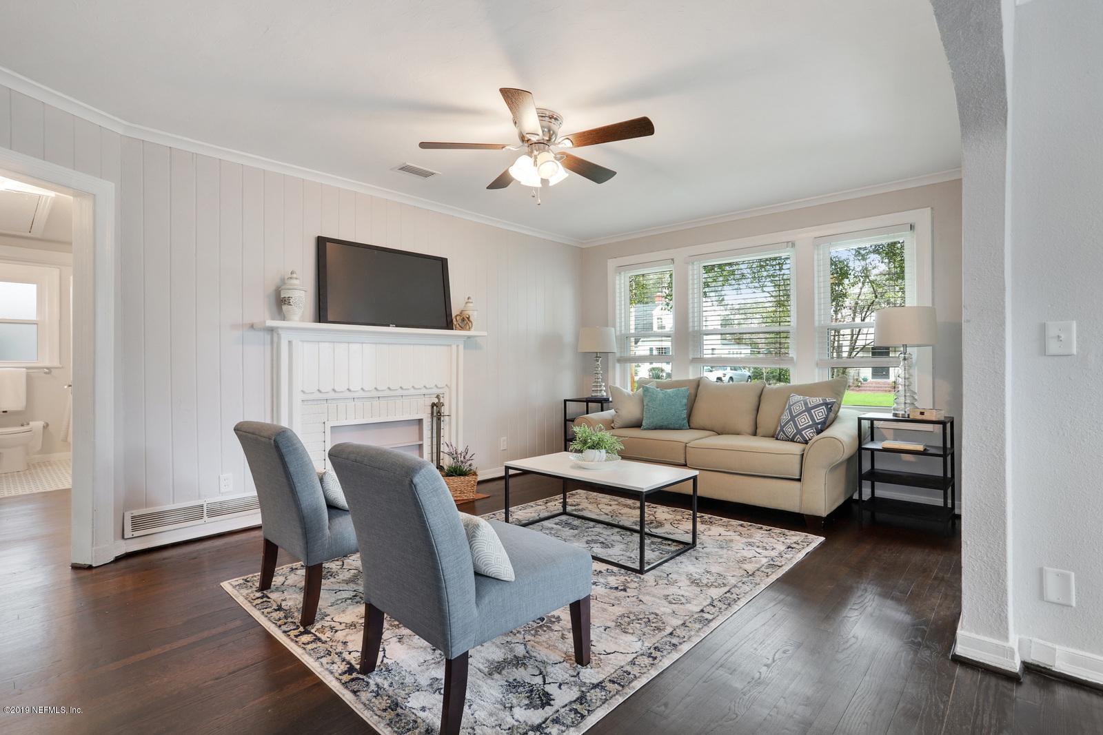 1674 Charon Road Jacksonville, FL 32205 - Photo 3 of 6 a living room with furniture a fireplace and a flat screen tv