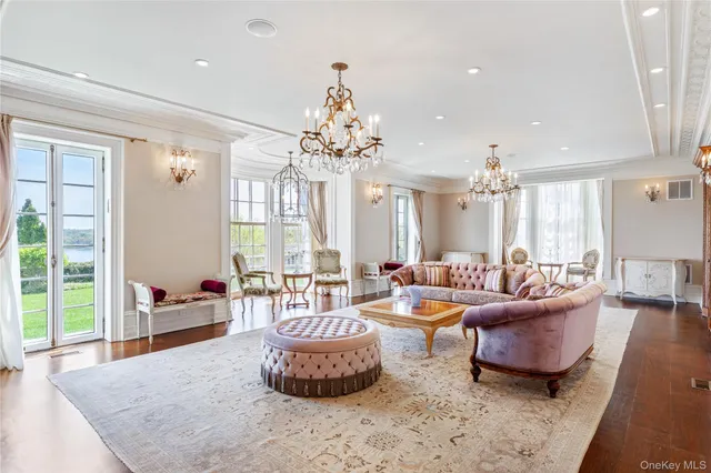 a living room with furniture and a chandelier