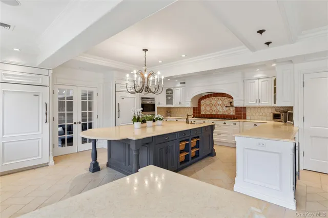 a large kitchen with kitchen island a sink a stove a dining table and chairs