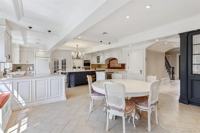 a large kitchen with a table and chairs