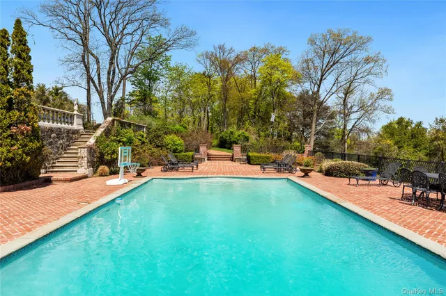 a swimming pool with outdoor seating and yard
