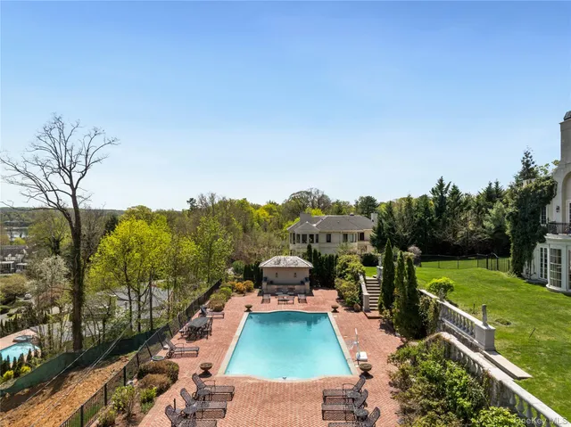 a view of a swimming pool and trees in the background