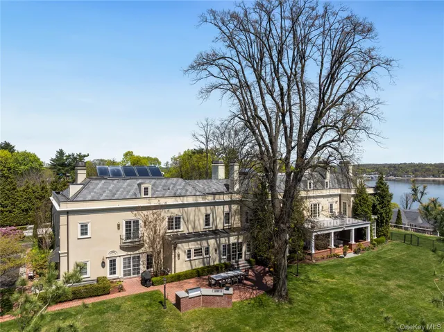 a view of a house with a yard balcony and sitting area