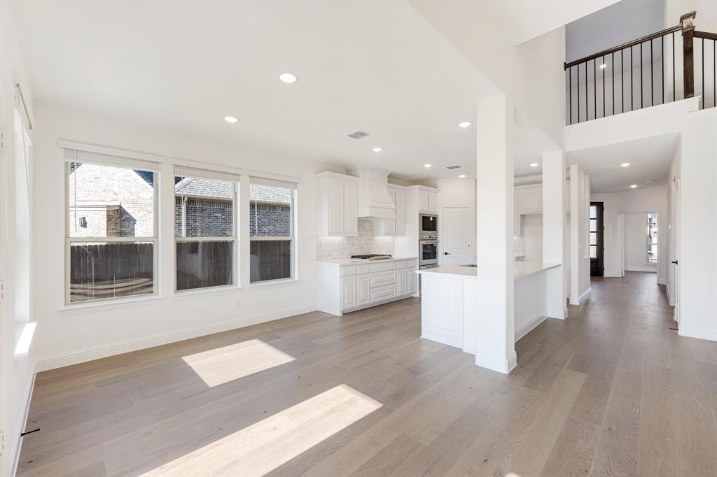 2401 Rileigh Lane Mansfield, TX 76063 - Photo 11 of 40 a view of a big room with wooden floor and windows