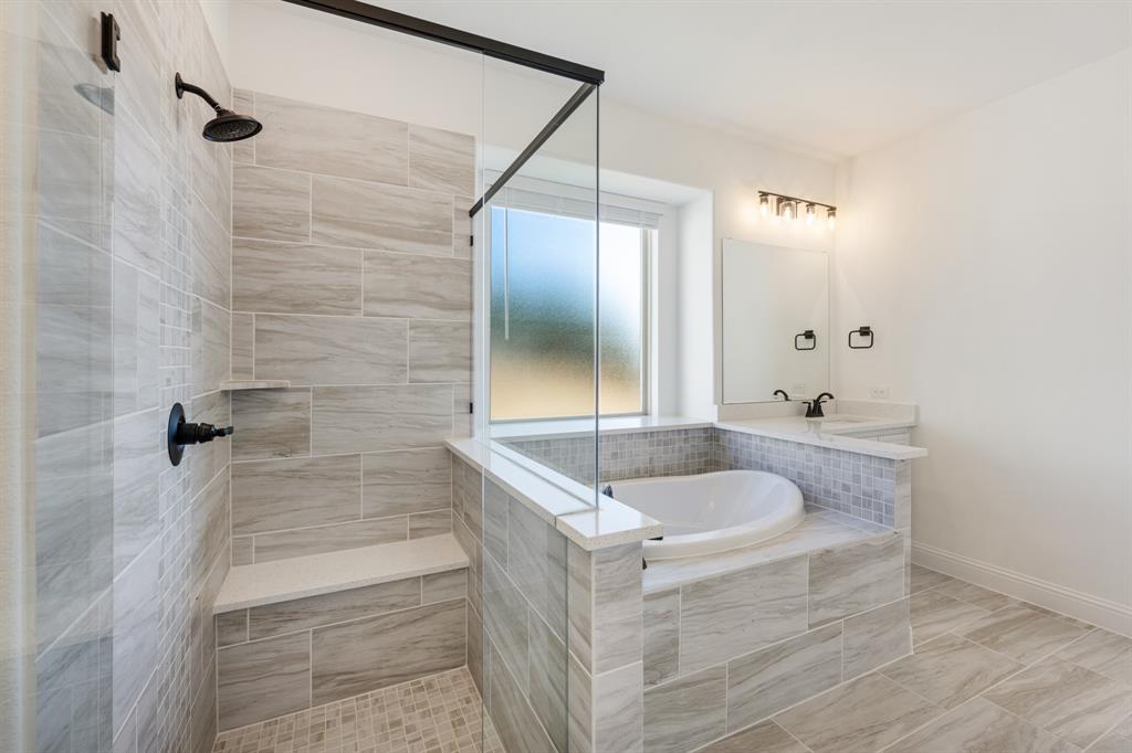 2401 Rileigh Lane Mansfield, TX 76063 - Photo 22 of 40 a bathroom with a granite countertop sink a bathtub and shower