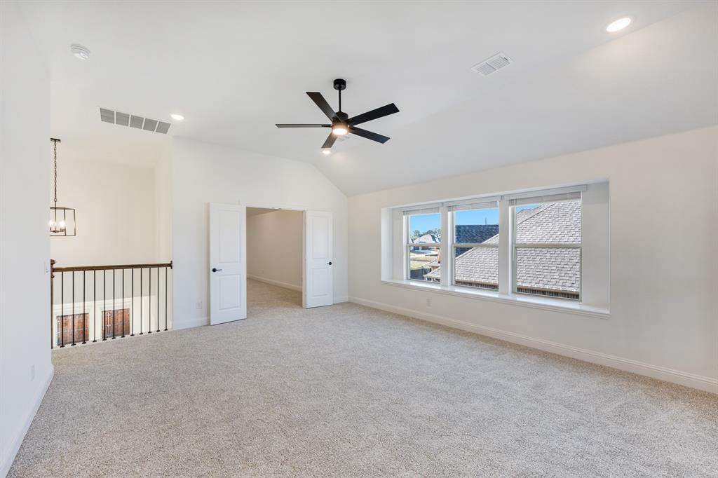 2401 Rileigh Lane Mansfield, TX 76063 - Photo 25 of 40 an empty room with chandelier fan and windows