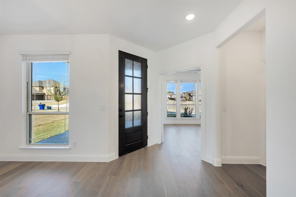 2401 Rileigh Lane Mansfield, TX 76063 - Photo 3 of 40 a view of a living room with windows and wooden floor