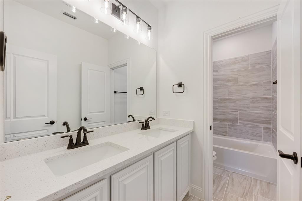 2401 Rileigh Lane Mansfield, TX 76063 - Photo 33 of 40 a bathroom with a sink and a mirror