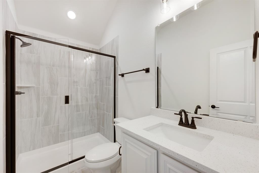 2401 Rileigh Lane Mansfield, TX 76063 - Photo 35 of 40 a bathroom with a sink toilet a mirror and shower